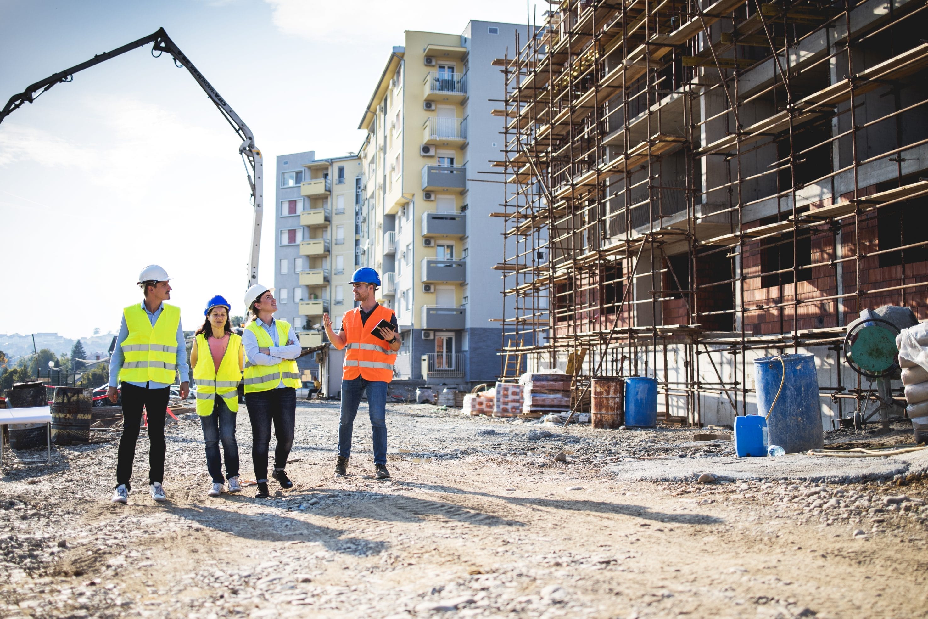 Construction Team Discussing Radon Services at New Building Site
