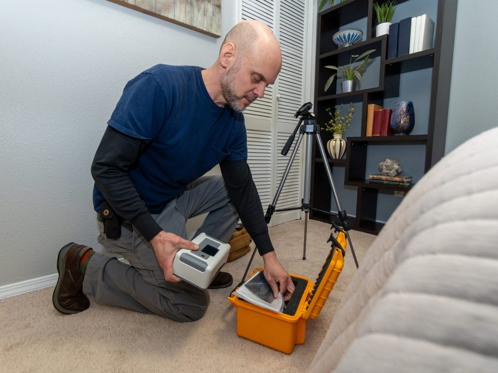 Man Performing Radon Testing in an office

