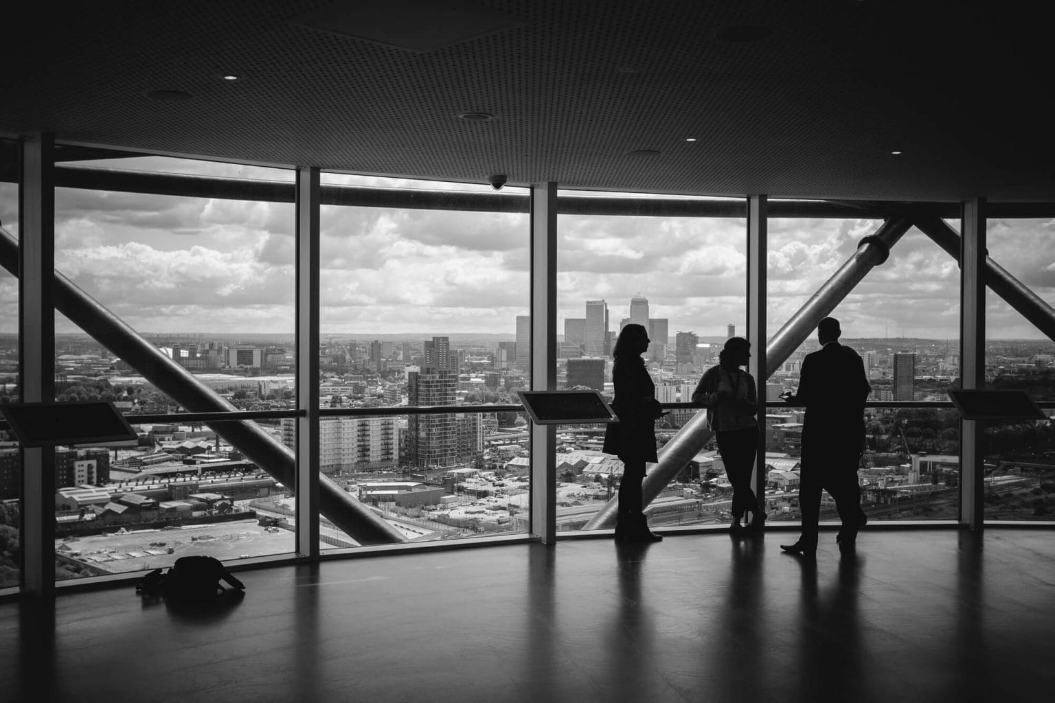 People Overlooking City Skyline discussing Radon Services